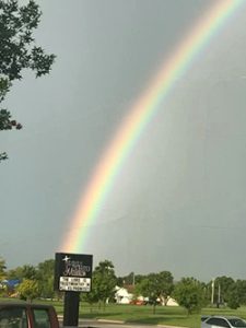 A rainbow in the sky over the Union Rescue Mission sign.