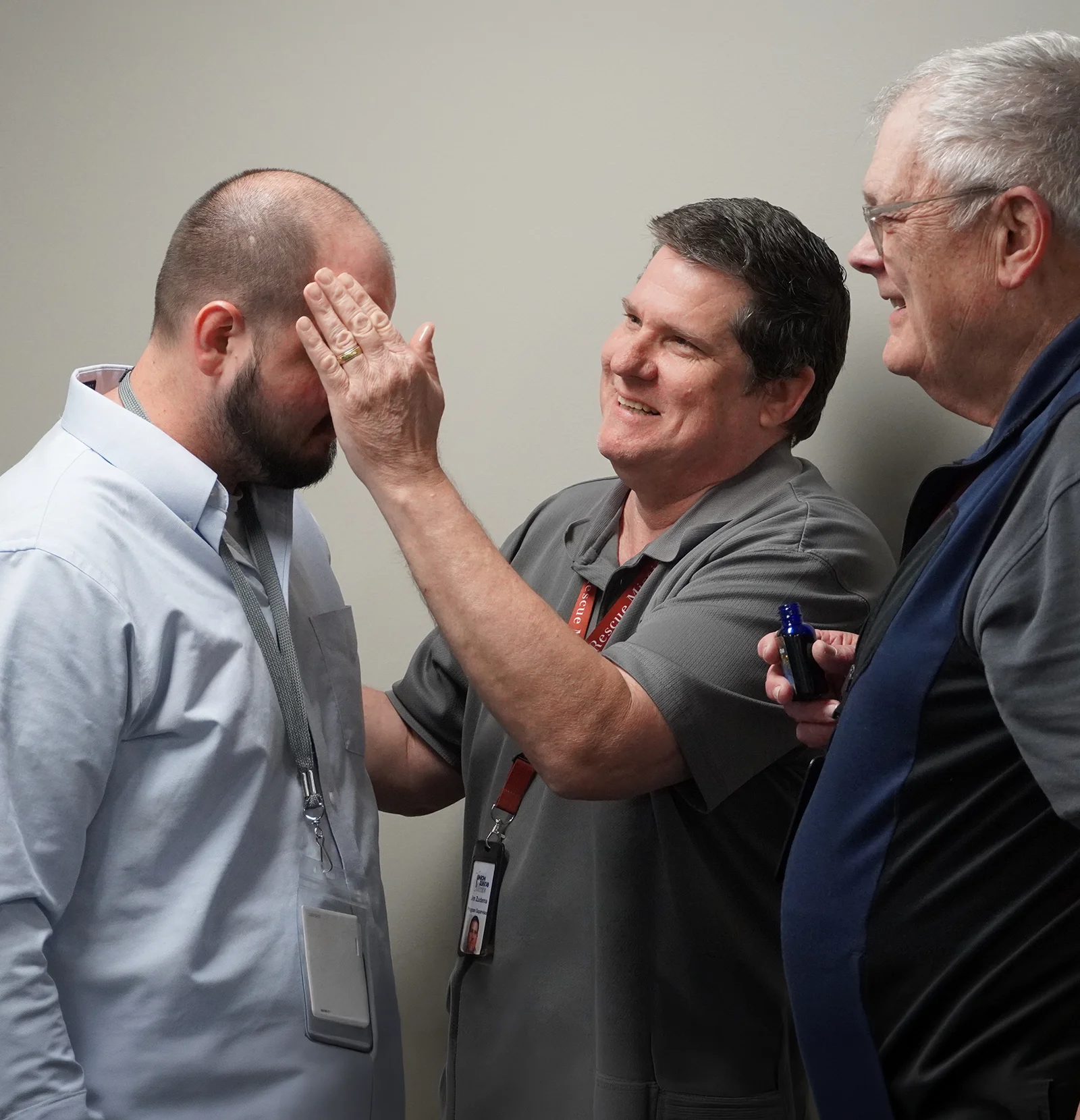 chaplain tom myers praying over particpant