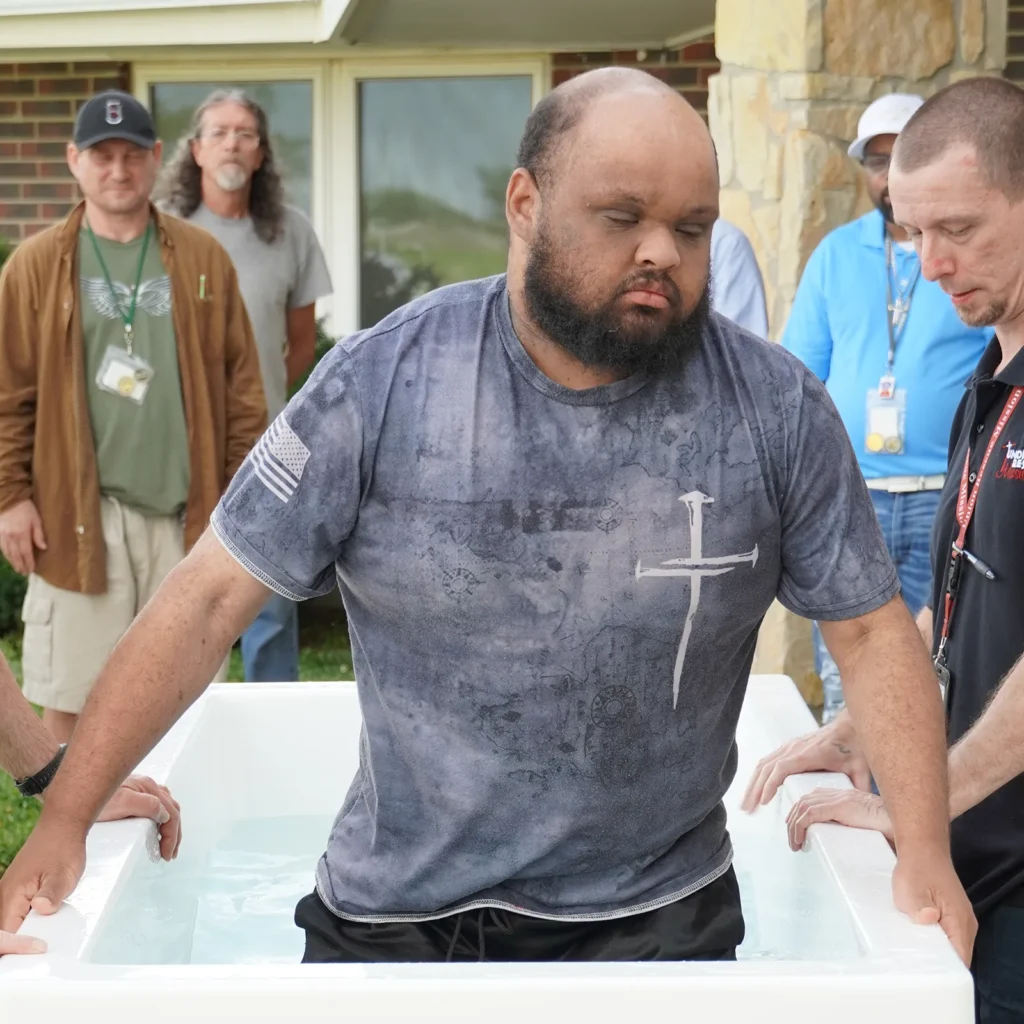 man at urm wichita being baptized